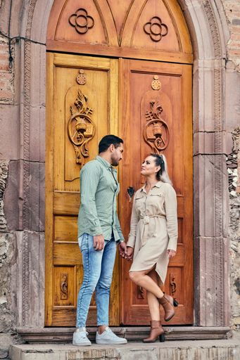 Young latin male and female couple looking at each other in love between 25 and 35 years old