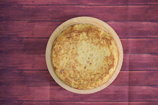 A tasty cake with egg yolk on a wooden table