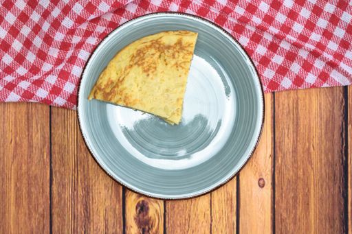 A tasty cake with an egg yolk on a wooden table