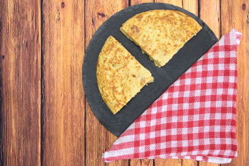 A tasty cake with an egg yolk on a wooden table