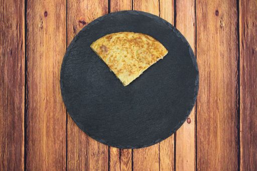 A tasty cake with an egg yolk on a wooden table