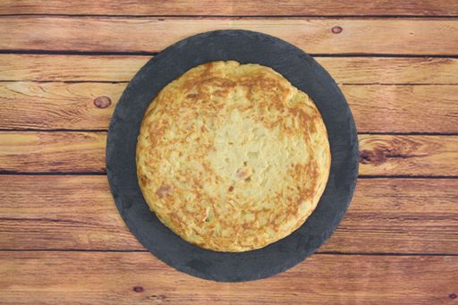 A closeup shot of a round omelet on a wooden table