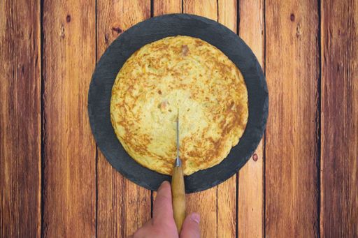 A tasty cake with an egg yolk on a wooden table