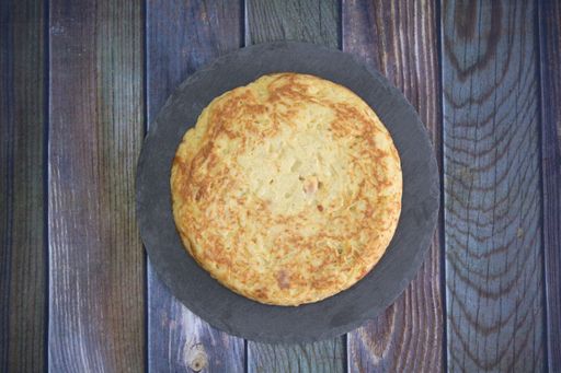 A tasty cake with egg yolk on a wooden table