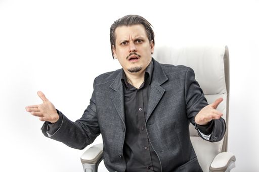 A businessman is surprised about something. He is not sure what is going on.