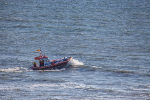 members of the dutch coastguard on a lifeboat on the north sea during a rescue drill