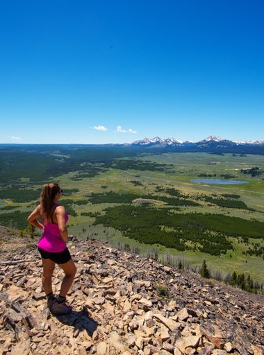 A rear view of a woman hiker resting in Yellowstone National Park, USA