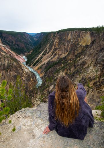 A rear view of a woman hiker resting in Yellowstone National Park, USA