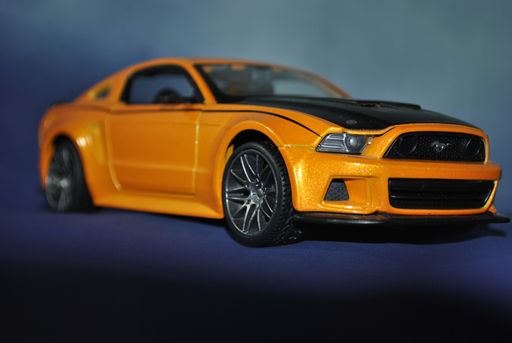 A closeup shot of a yellow toy car