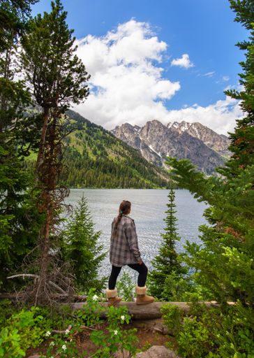 A beautiful Caucasian woman resting in Jenny Lake at Grand Teton National Park, USA
