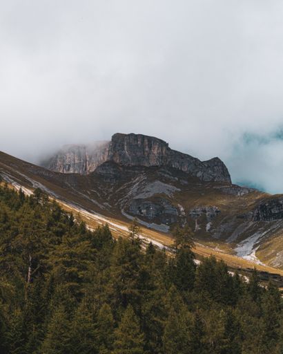 A mesmerizing shot of the summit covered with foggy clouds
