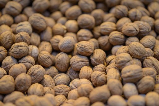 A closeup of walnuts under the lights in a market with a blurry background - perfect for food concepts