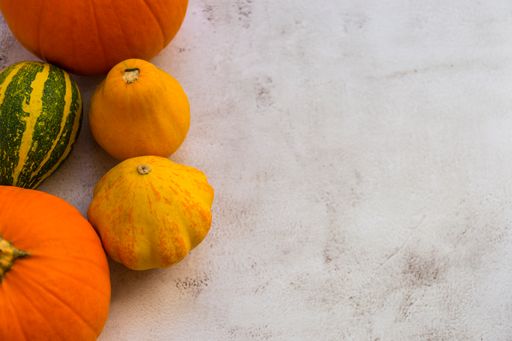 An overhead shot of pumpkins on a bright background and space for text