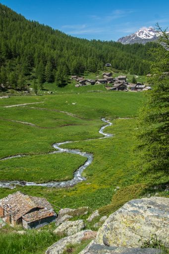 A vertical shot of Lake Superior of  Fusine (Tarvisio) with a green forest in Italy