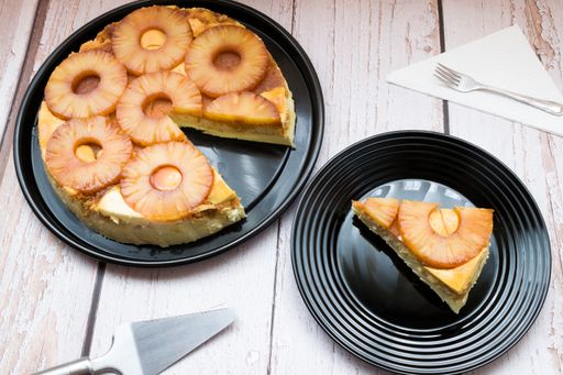 A beautiful shot of delicious pineapple cheesecake on a black plate