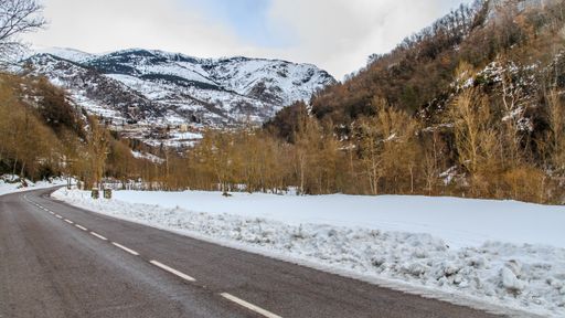 An asphalt highway through the countryside in winter