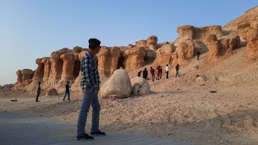 A group of tourists walking to the cliffs of Jabal Qara, Hofuf al Hasa, Saudi Arabia