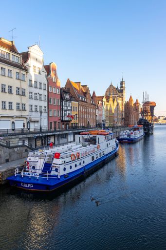A vertical shot of a riverside in the old town of Gdansk, Poland