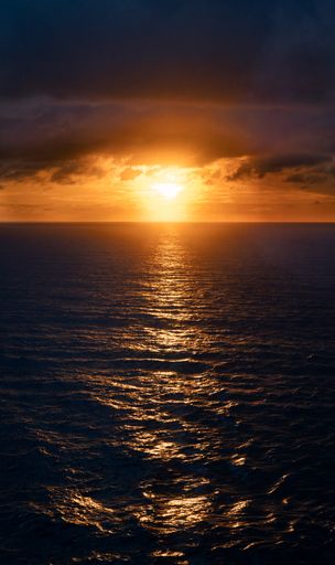 A vertical shot of a sunset over the Atlantic Ocean