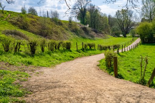 A narrow path in the countryside surrounded by green valley