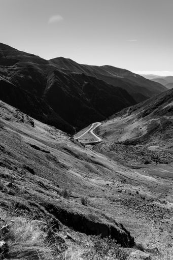 A vertical shot of a road in a mountain