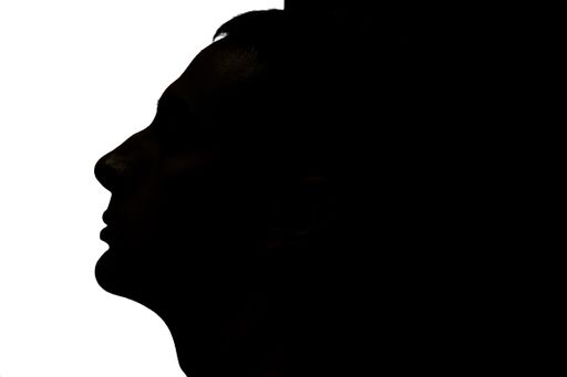 Portrait of the silhouette of a man. Profile view of silhouette of a man with black and white background.