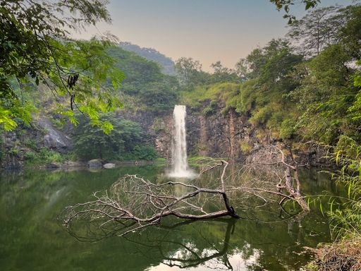 A beautiful shot of a waterfall surrounded by trees in Yeoor,India.