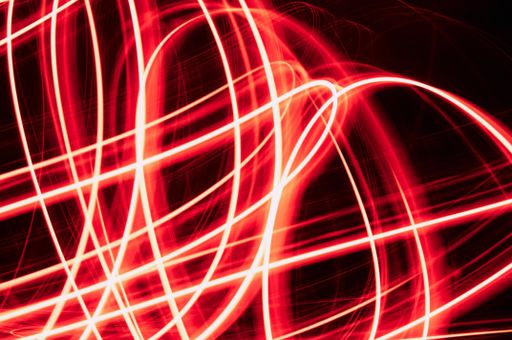 A futuristic bright red fiber abstract lights on a dark background