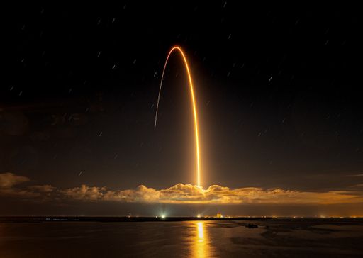 A beautiful shot of a rocket launched against a dark night sky
