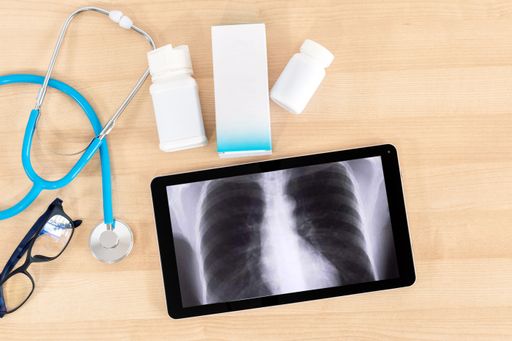 A closeup of the medical equipment on the wooden table. Top view. Workplace of a doctor.