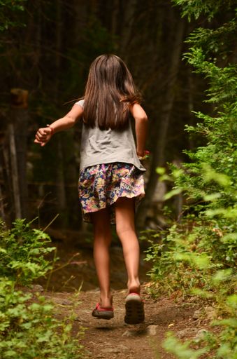 A girl running along the path in the forest