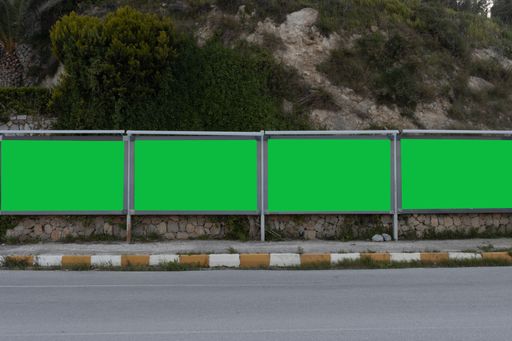 A series of green screens for ads at the side of a road, an excellent space for your text