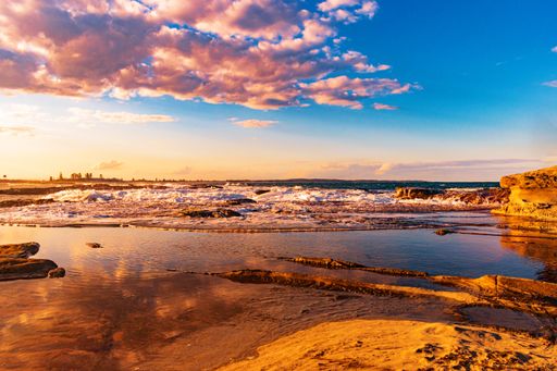 A beautiful high angle shot of a seashore with the sea on the background at sunset