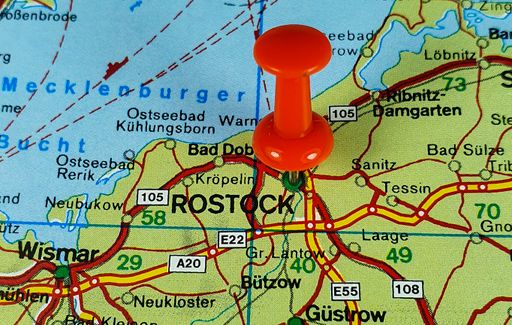 A close-up shot of the map with a red pin showing the location of Rostock city in Germany