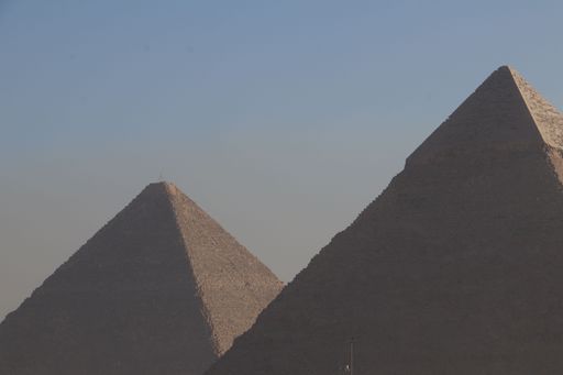 The iconic Pyramids of Giza under a clear blue sky, showcasing ancient Egyptian architecture.