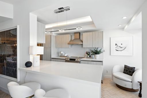 Stylish, light-filled condo with panoramic city views, sleek designer interiors, custom kitchen, luxe bathrooms, and elegant living space.