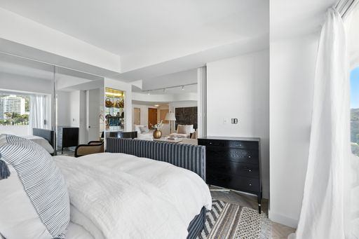 Stylish, light-filled condo with panoramic city views, sleek designer interiors, custom kitchen, luxe bathrooms, and elegant living space.