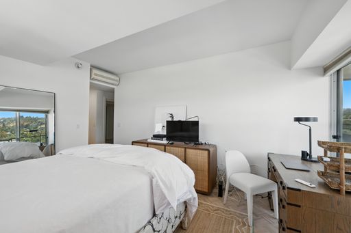 Stylish, light-filled condo with panoramic city views, sleek designer interiors, custom kitchen, luxe bathrooms, and elegant living space.