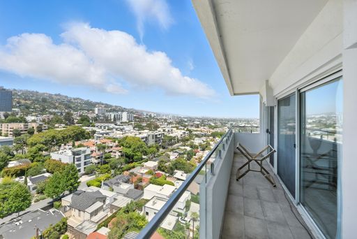 Stylish, light-filled condo with panoramic city views, sleek designer interiors, custom kitchen, luxe bathrooms, and elegant living space.