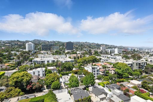 Stylish, light-filled condo with panoramic city views, sleek designer interiors, custom kitchen, luxe bathrooms, and elegant living space.