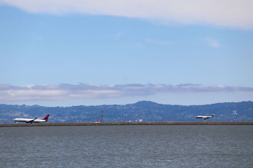 Delta Airlines Boeing 737-900 and Vista America Bombardier Challenger 300 landing at San Francisco airport