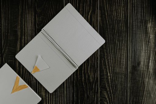An overhead shot of an open notebook on a wooden table - motivational concept