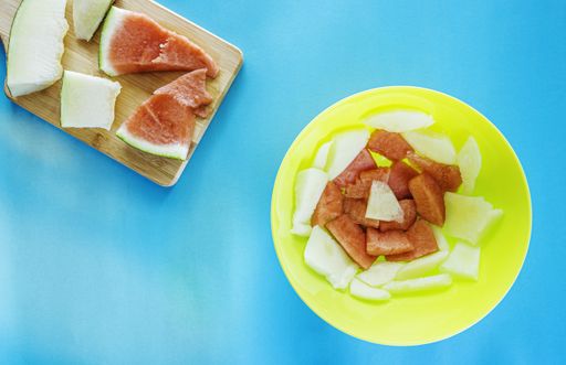 An overhead shot of cut fruits with light blue background - perfect for wallpaper