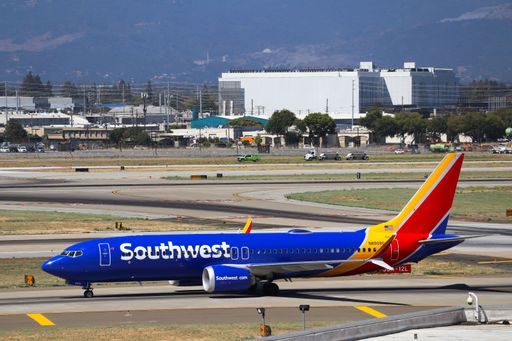 Southwest Airlines Boeing 737 MAX 8 taxiing to the gates at San Jose international airport with Santa Cruz mountains in the background