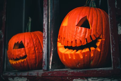 A closeup shot of Halloween pumpkins with spooky faces