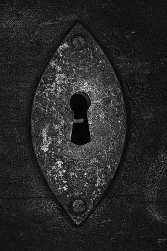 A grayscale closeup shot of a metal lock