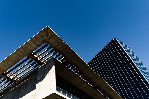 A low angle shot of modern buildings under the sunlight and a blue sky