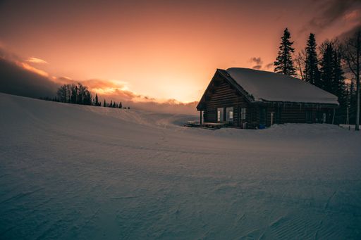 A beautiful shot of a ski lodge on the crest of the mountain with a background of sunset in Telluride, Colorado.