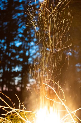 A Closeup of a bonfire with a blurry dark background