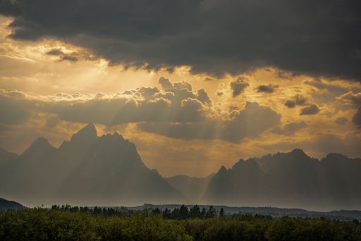 A scenic sunset behind the clouds over the Grand Teton National Park in Wyoming